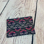 Load image into Gallery viewer, a black and white striped purse with pink flowers on it
