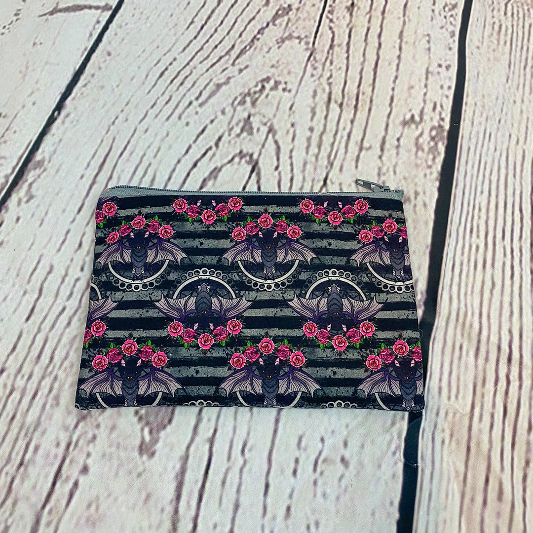 a small purse sitting on top of a wooden floor