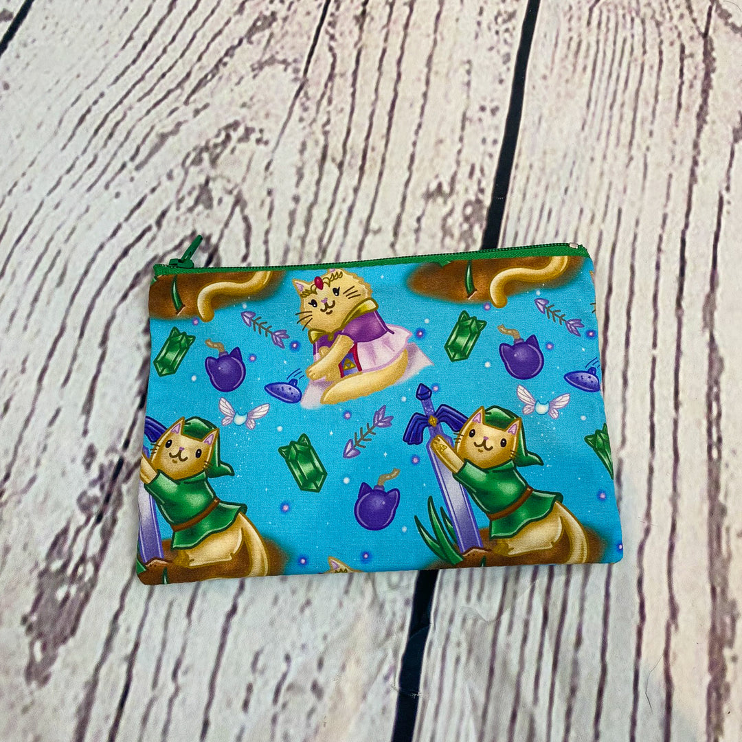 a small pouch with a picture of two cats on it