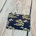 Load image into Gallery viewer, a small zipper bag with a pattern of dinosaurs on it
