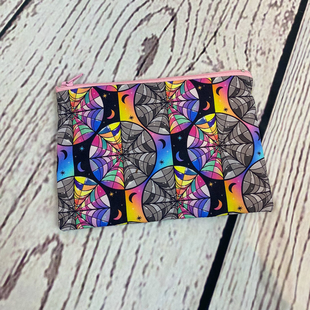 a colorful wallet sitting on top of a wooden table