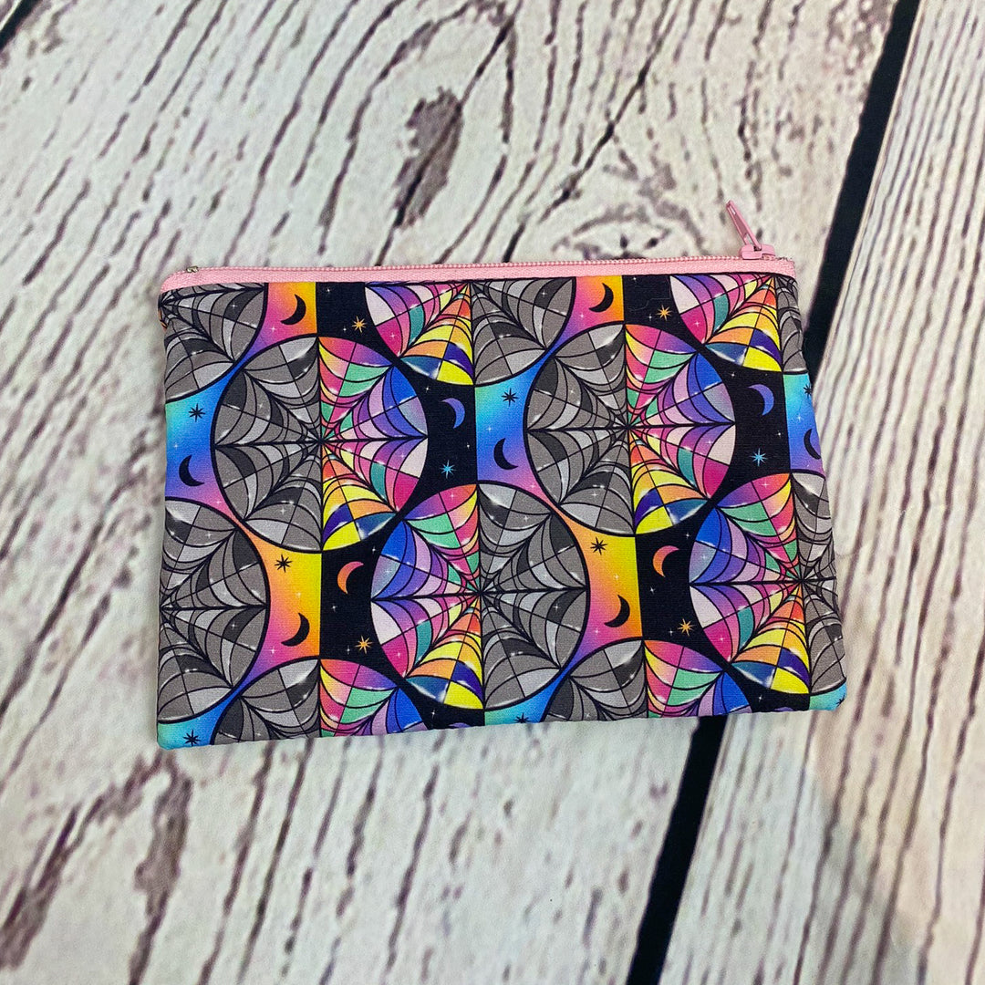 a colorful wallet sitting on top of a wooden table